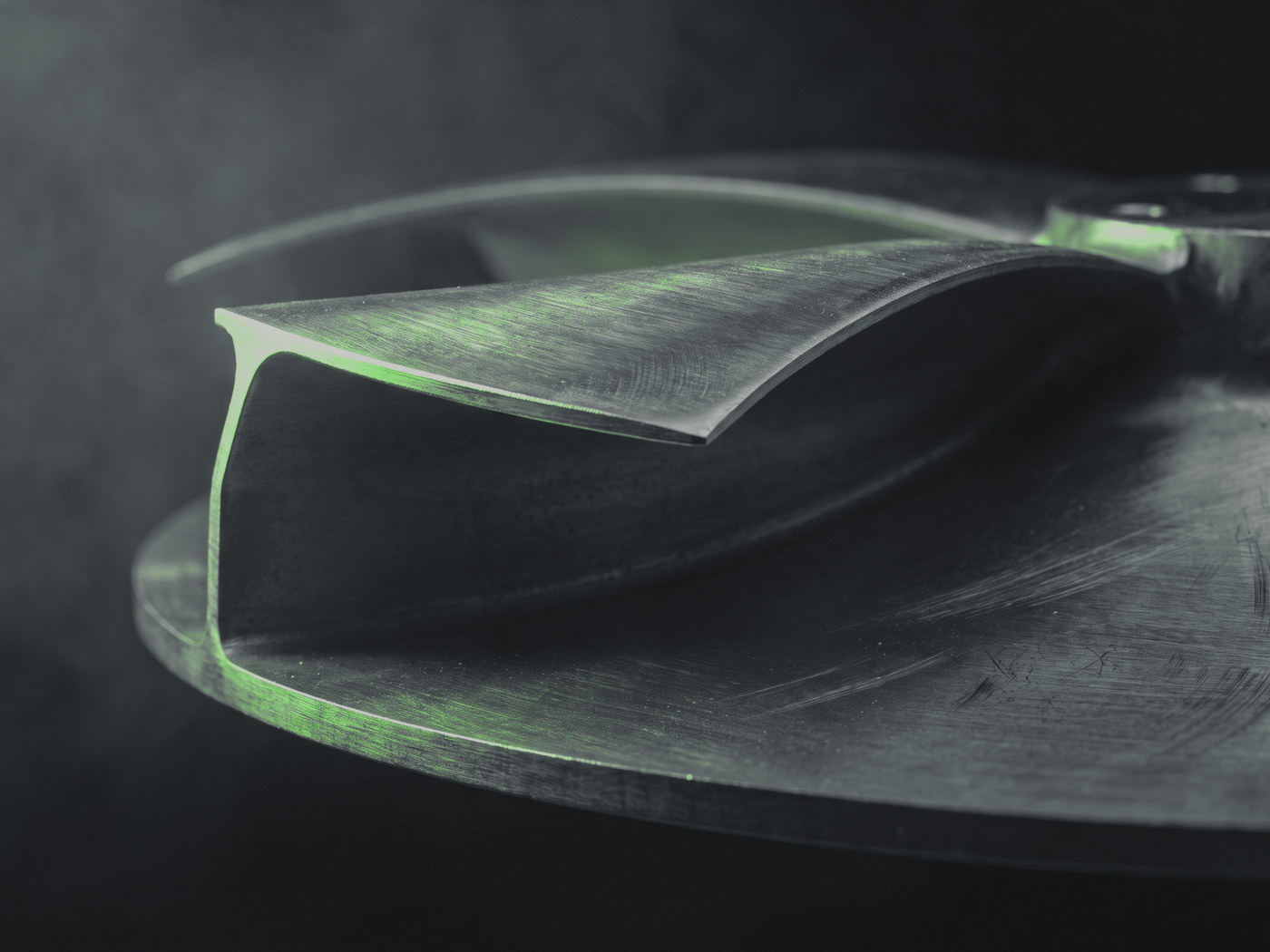 A machined centrifugal impeller, blade edges lit